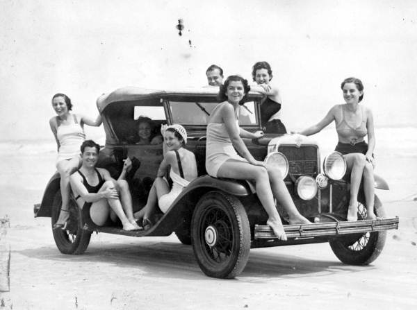 Men and women at the beach, posed on a convertible roadster, Daytona Beach, 1932