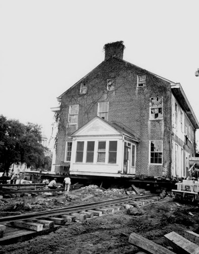 The Columns home is lifted to move from Adams Street to its current location on the northwest corner of Duval Street and Park Avenue, August 26, 1971. Courtesy of the State Archives of Florida.
